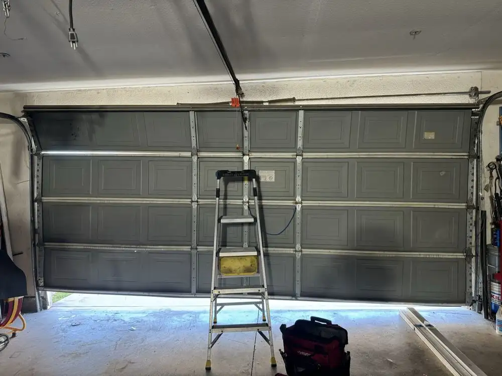 Cali Pros Garage Door assessing a garage door to determine whether repair or replacement is the better option