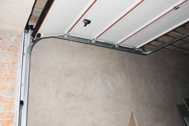 Cali Pros Garage Door technician examining garage door springs weakened by intense Southern California heat
